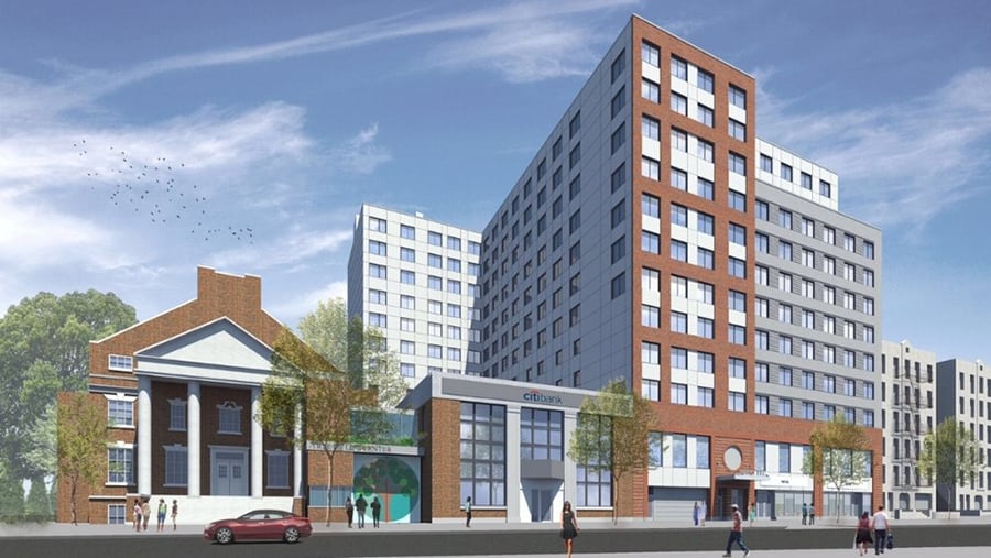 Rendering of Community Healthcare Network Jamaica Health Clinic shows a modern multi-story building with red and white facades stands next to a brick church with white columns, a Citibank branch, and trees under a blue sky with scattered clouds. Cars and people are on the street.