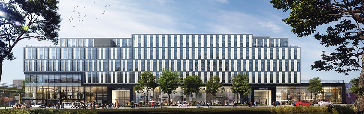 Image of 2440 Fulton Street showing a modern, multi-story office building with glass and metal facade, street-level shops, trees along the sidewalk, people walking, and cars driving by under a blue sky with scattered clouds and birds.