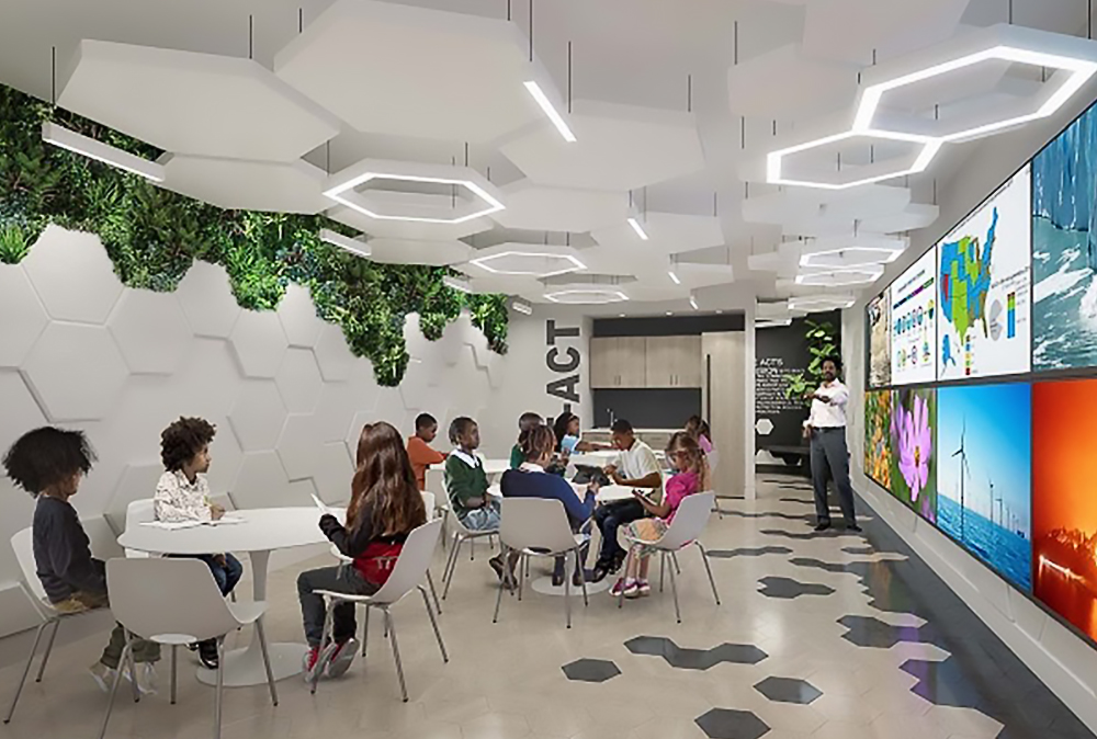 Rendering of WE ACT's new headquarters. Children sit at tables in a modern classroom with hexagonal lights, green wall plants, and large digital screens displaying maps and images, while an instructor stands at the front of the room.