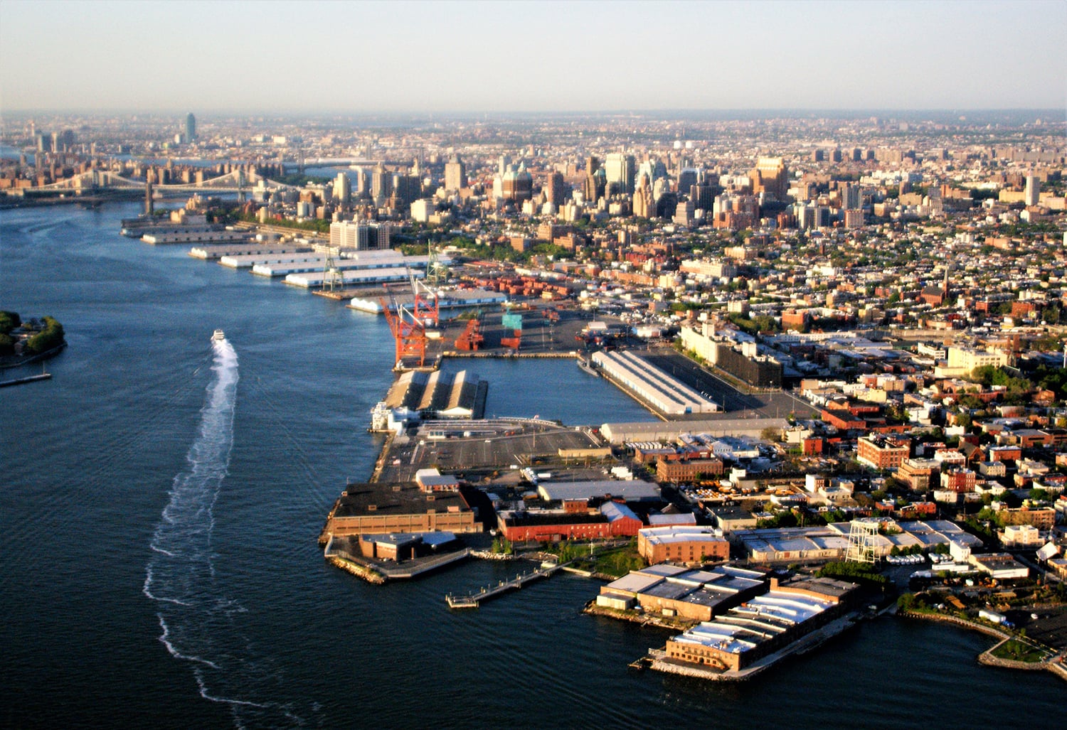 Aerial view of Brooklyn Marine Terminal showing a waterfront with Red Hook in foreground and East River in background.