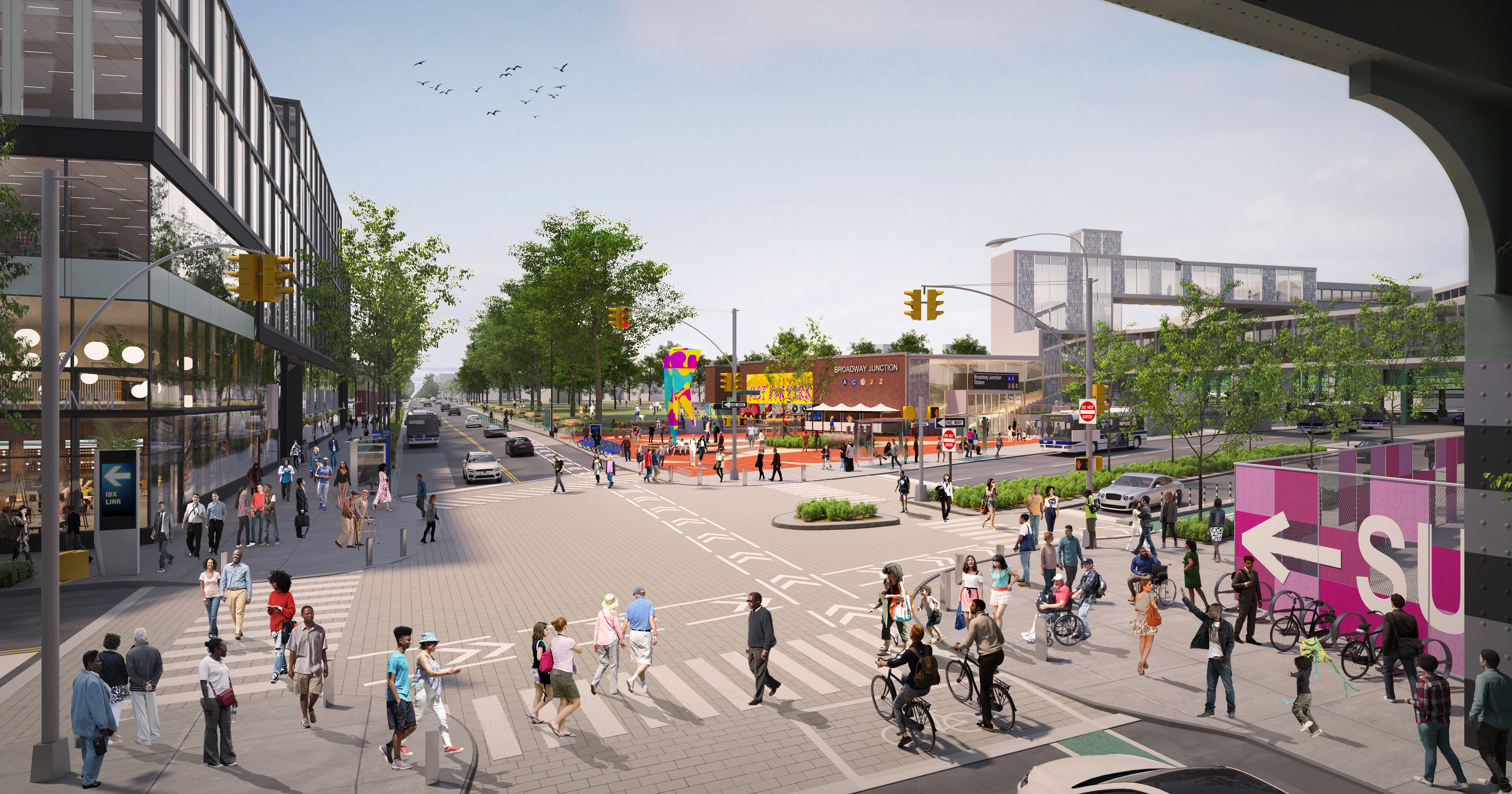 Rendering of Broadway Junction showing busy intersection with many pedestrians, cyclists, and cars. Trees line the streets, colorful public art and a playground are visible, and modern buildings surround the area under a partly cloudy sky.