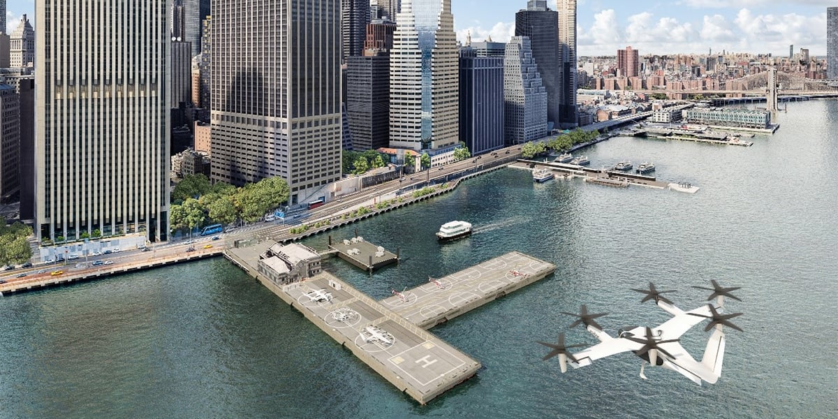 Aerial rendering of downtown Manhattan heliport with a flying air taxi above water, surrounded by New York City skyscrapers and a ferry at the dock.