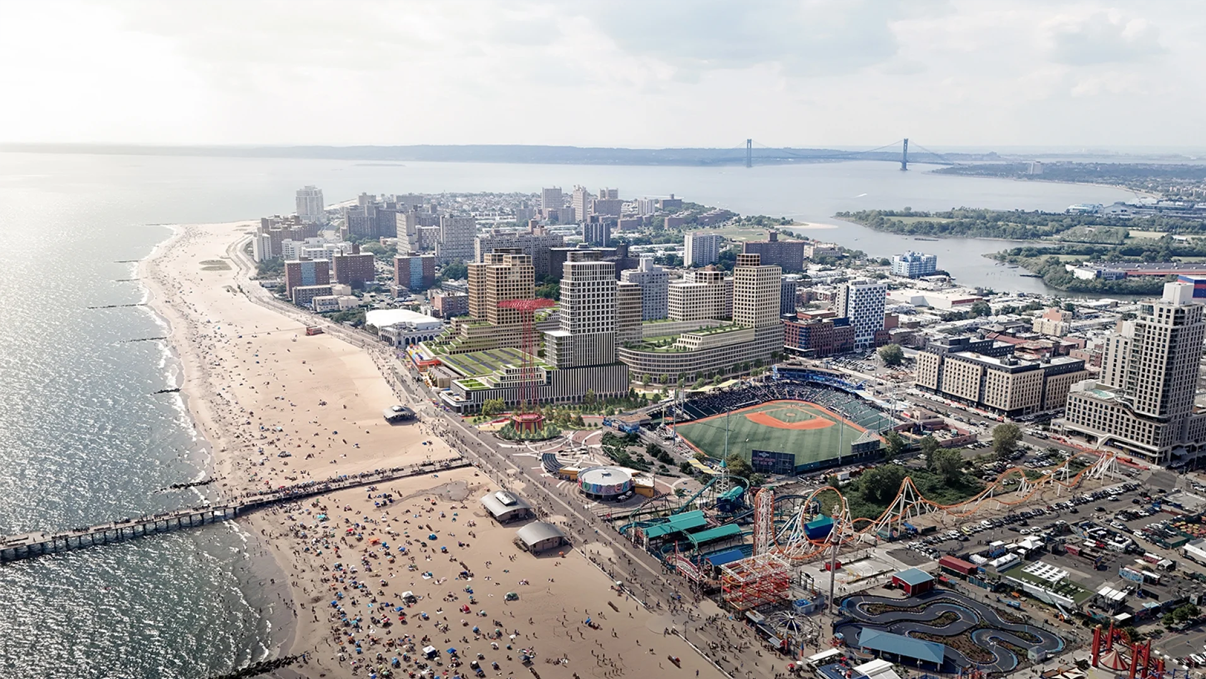 Aerial view of a Coney Island featuring a long sandy beach crowded with people, an amusement park with rides, a baseball stadium, and numerous buildings. The coastline curves with a distant bridge visible on the horizon.