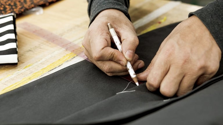 Hands Marking a Garment. Photo by Mac Shafer/NYCEDC