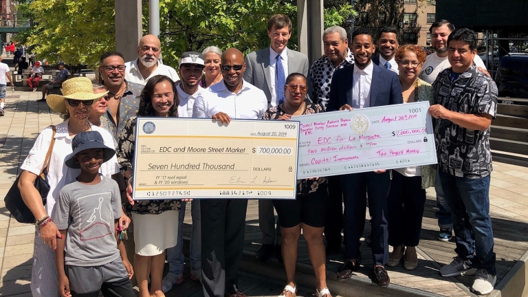 Brooklyn Borough President Eric L. Adams, NYCEDC President and CEO James Patchett, Council Member Antonio Reynoso, and community members celebrate a $2.7M investment to renovate Moore Street Market
