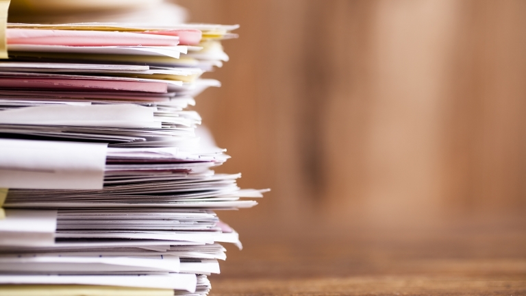 Documents on table. Photo by Getty Images.