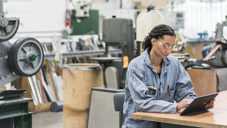 Industrial Worker on tablet. Photo by Getty Images.