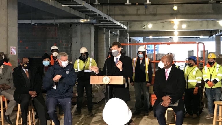 City officials giving remarks at the Beach 21 housing development topping off