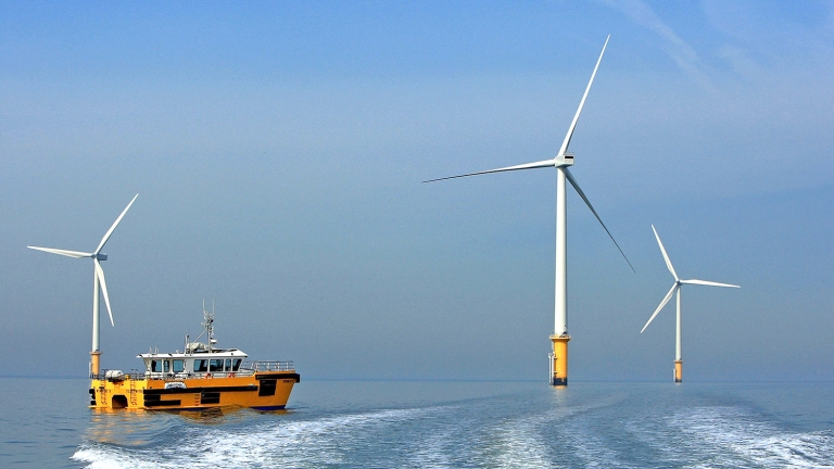 Fully Operational Wind Farm with Turbines and a Boat