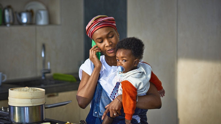 Woman with baby son in kitchen