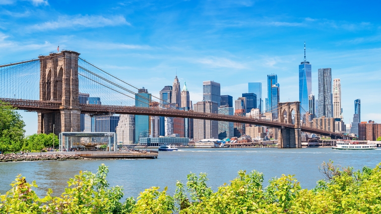 The Brooklyn Bridge and the skyline of New York City USA as seen form Brooklyn, across the East River, on a sunny summer day. The Brooklyn Bridge and the skyline of New York City USA as seen form Brooklyn, across the East River, on a sunny summer day.