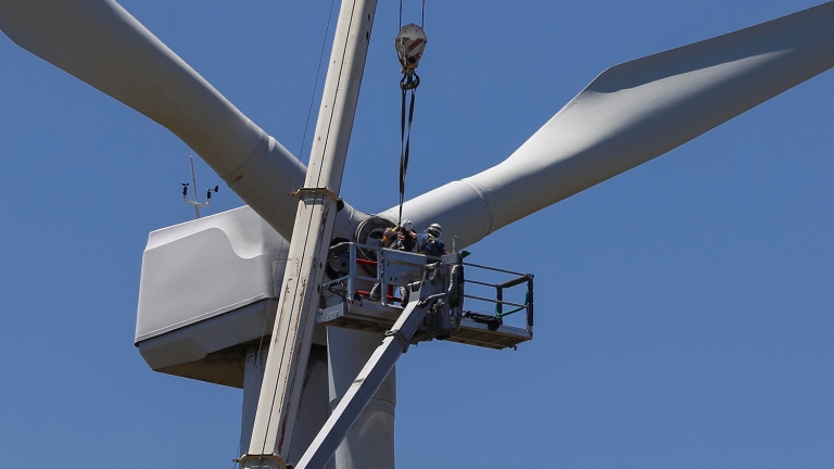 Two people conducting wind turbine maintenance