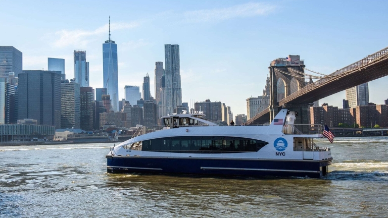 NYC Ferry boat in front of Brooklyn Bridge