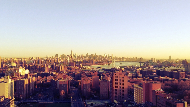 Panoramic view of the New York City skyline taken from Brooklyn at sunrise showing the boroughs of Manhattan, Brooklyn, Queens and The Bronx as well as the East River.