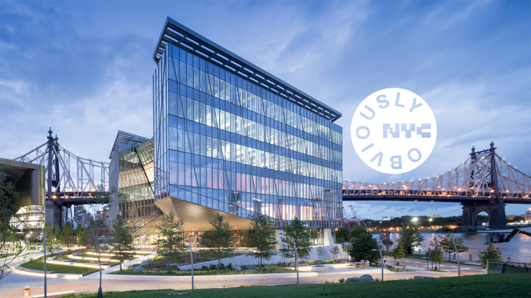 A modern glass building sits near a river with a large bridge in the background at sunset. A round white graphic with the words “OBVIOUSLY NYC” overlays the sky in the upper right corner.