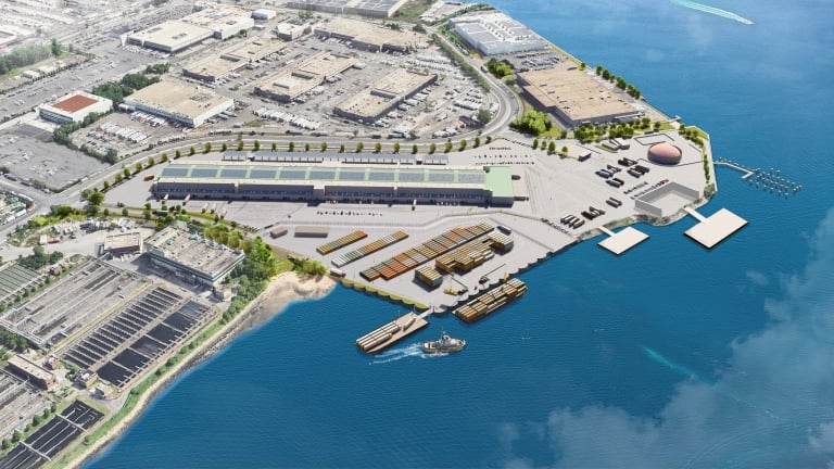 Aerial rendering of Hunts Point Marine Terminal showing an industrial waterfront facility with warehouses, shipping containers, vehicles, docks, boats, and nearby buildings, bordered by blue water and a marina area. Photo courtesy of NYCEDC. Aerial rendering of Hunts Point Marine Terminal showing an industrial waterfront facility with warehouses, shipping containers, vehicles, docks, boats, and nearby buildings, bordered by blue water and a marina area. Photo courtesy of NYCEDC.
