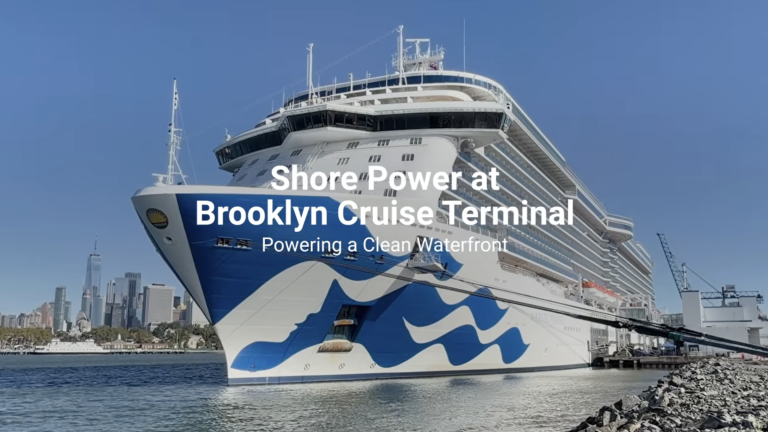 A large cruise ship docked at the Brooklyn Cruise Terminal with text overlay reading, Shore Power at Brooklyn Cruise Terminal: Powering a Clean Waterfront.