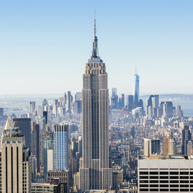 New York cityscape seen from above with clear blue sky.