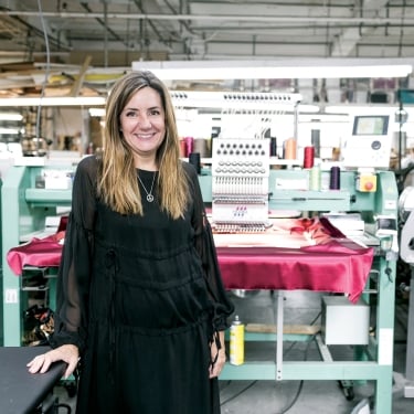 Woman in garment studio. Photo by Mac Shafer/NYCEDC