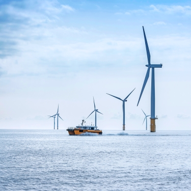 View of offshore windfarm and service boat