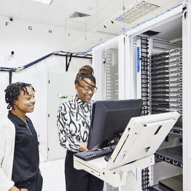 IT professionals in discussion while configuring server in data center