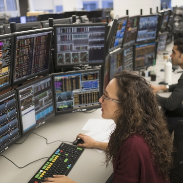 Young traders analyzing computer data