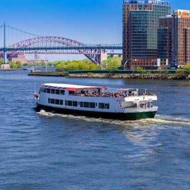 Tour Boat traversing the East River toward Astoria, Queens, New York City Tour Boat traversing the East River toward Astoria, Queens, New York City