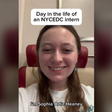 Smiling woman with long hair sits in a chair. Text reads &quot;Day in the life of an NYCEDC intern.&quot; Subtitle at the bottom says &quot;I’m Sophia Ortiz-Heaney.&quot;