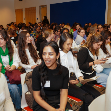 Auditorium of women talking.