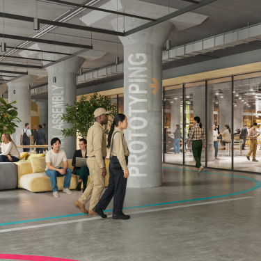 Interior rendering of BATWorks shows a modern, open-concept workspace with groups of people collaborating, lounge seating, glass-walled meeting rooms, and large labeled columns reading ASSEMBLY and PROTOTYPING. Some people are working, walking, or talking. Interior rendering of BATWorks shows a modern, open-concept workspace with groups of people collaborating, lounge seating, glass-walled meeting rooms, and large labeled columns reading ASSEMBLY and PROTOTYPING. Some people are working, walking, or talking.