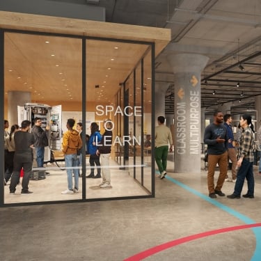 BATWorks interior rendering shows people gathering inside and outside a glass-walled room labeled Space to Learn in BATWorks, a modern, industrial-style building. Some walk by, while others interact or observe in the bright, open classroom. BATWorks interior rendering shows people gathering inside and outside a glass-walled room labeled Space to Learn in BATWorks, a modern, industrial-style building. Some walk by, while others interact or observe in the bright, open classroom.