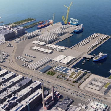 Aerial rendering of South Brooklyn Marine Terminal with large cranes, cargo ships docked, and rows of wind turbine blades and components stored on the docks, adjacent to modern buildings and parked vehicles.