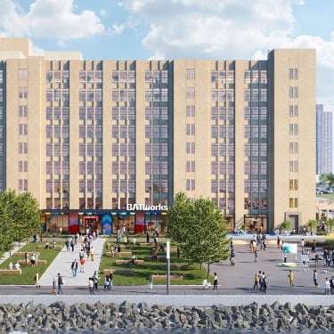 Exterior rendering of BATWorks shows a white NYC Ferry with passengers sailing along the waterfront. Behind it, a large tan building labeled BATWorks stands, with a green lawn, people walking, and trees in front. The sky is partly cloudy.
