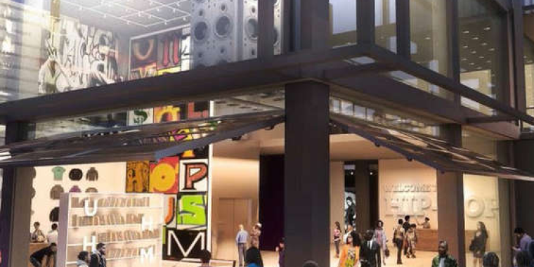 Rendering of Universal Hip-Hop Museum in Bronx Point, featuring a lively street scene outside a modern glass-walled building with hip hop-themed art, clothing displays, and a blue lowrider car inside. People gather and walk around the entrance at night.