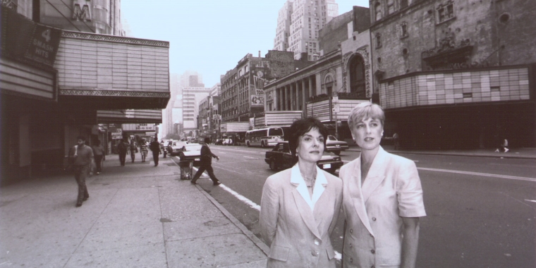 Rebecca Robertson (right) and Cora Cahan (left) stand with the empty theatres and stores of 42nd Street in the background. Credit: New York Times