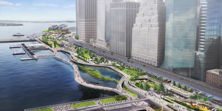 Rendering of Maiden Cove in the FiDi Seaport district of Manhattan showing a waterfront urban park featuring winding pathways, green spaces, and benches. Skyscrapers line the background, and a road runs parallel to the park. Boats and piers are visible on the water, with people enjoying the scenic area.