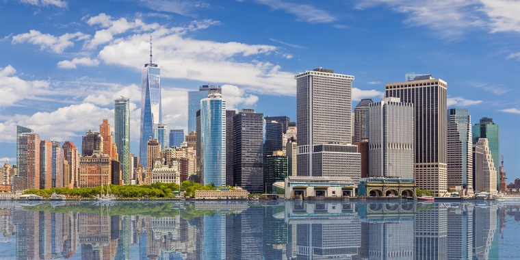 New York City Skyline with Manhattan Financial District and World Trade Center Reflected in Water of New York Harbor