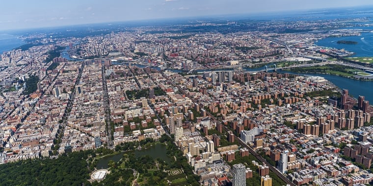 Aerial view of Central Park, Manhattan, and Harlem, and The Bronx in a distance behind, from a helicopter on a sunny summer day.