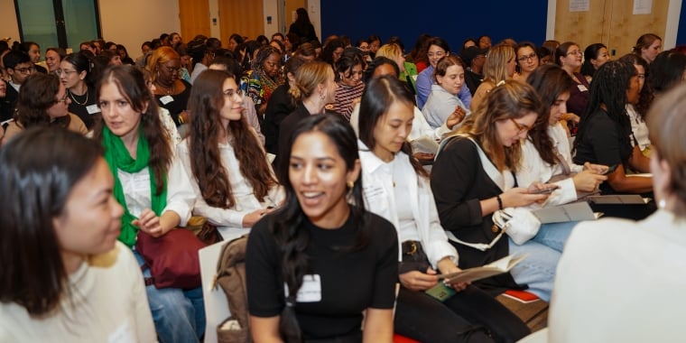 Auditorium of women talking.