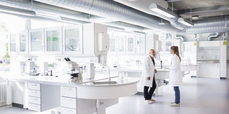 LEAP header shows two scientists in white lab coats stand and talk in a bright, modern laboratory with large windows, lab equipment, and white workstations.