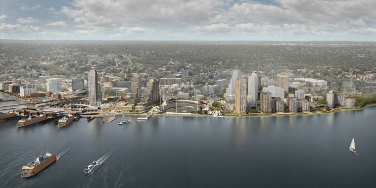 Aerial rendering of Staten Island North Shore with tall buildings, boats and ferries on the water, green spaces, and dense trees in the background. Credit: FXCollaborative.