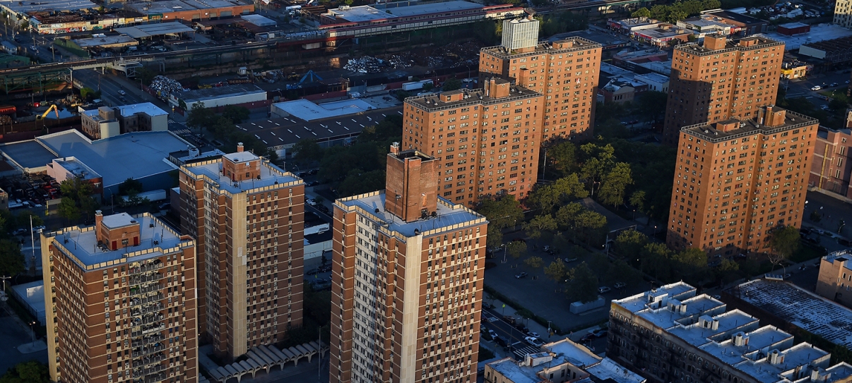 Show thumbnail preview Aerial view of several high-rise apartment buildings surrounded by trees and streets in an urban neighborhood, with industrial and commercial buildings visible in the background. Show thumbnail preview Aerial view of several high-rise apartment buildings surrounded by trees and streets in an urban neighborhood, with industrial and commercial buildings visible in the background.