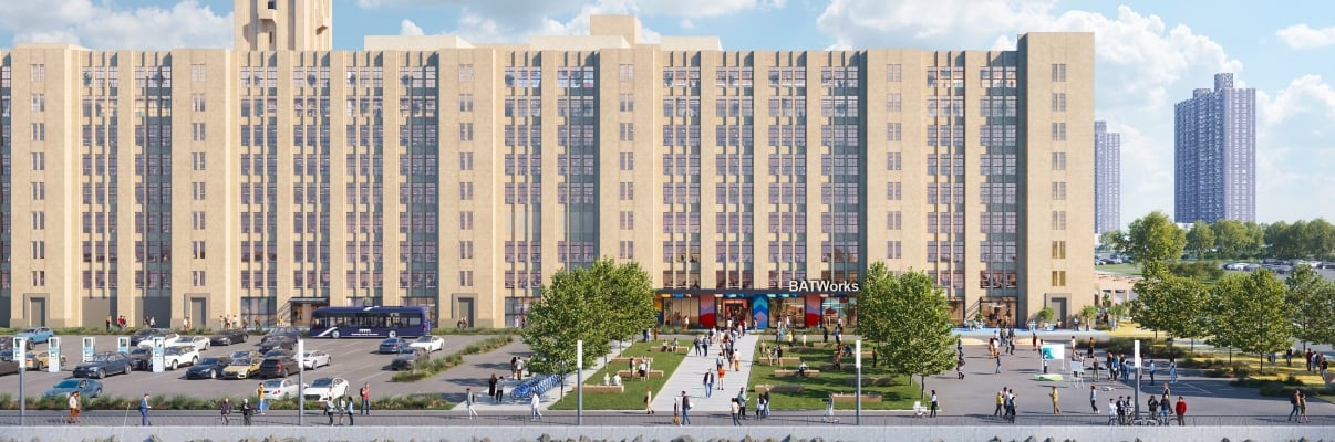 Exterior rendering of BATWorks shows a white NYC Ferry with passengers sailing along the waterfront. Behind it, a large tan building labeled BATWorks stands, with a green lawn, people walking, and trees in front. The sky is partly cloudy.