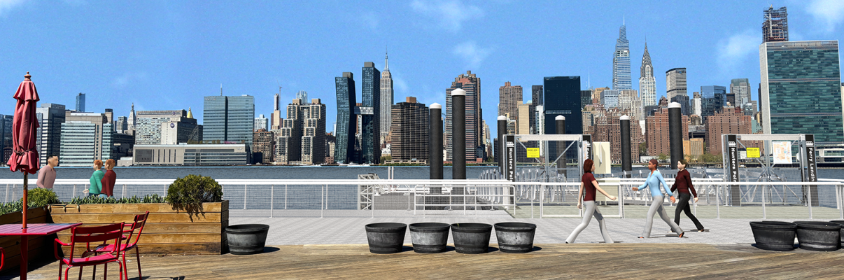 People walking and sitting on a wooden waterfront deck with planters and red tables; the New York City skyline and East River are visible under a clear blue sky in the background.